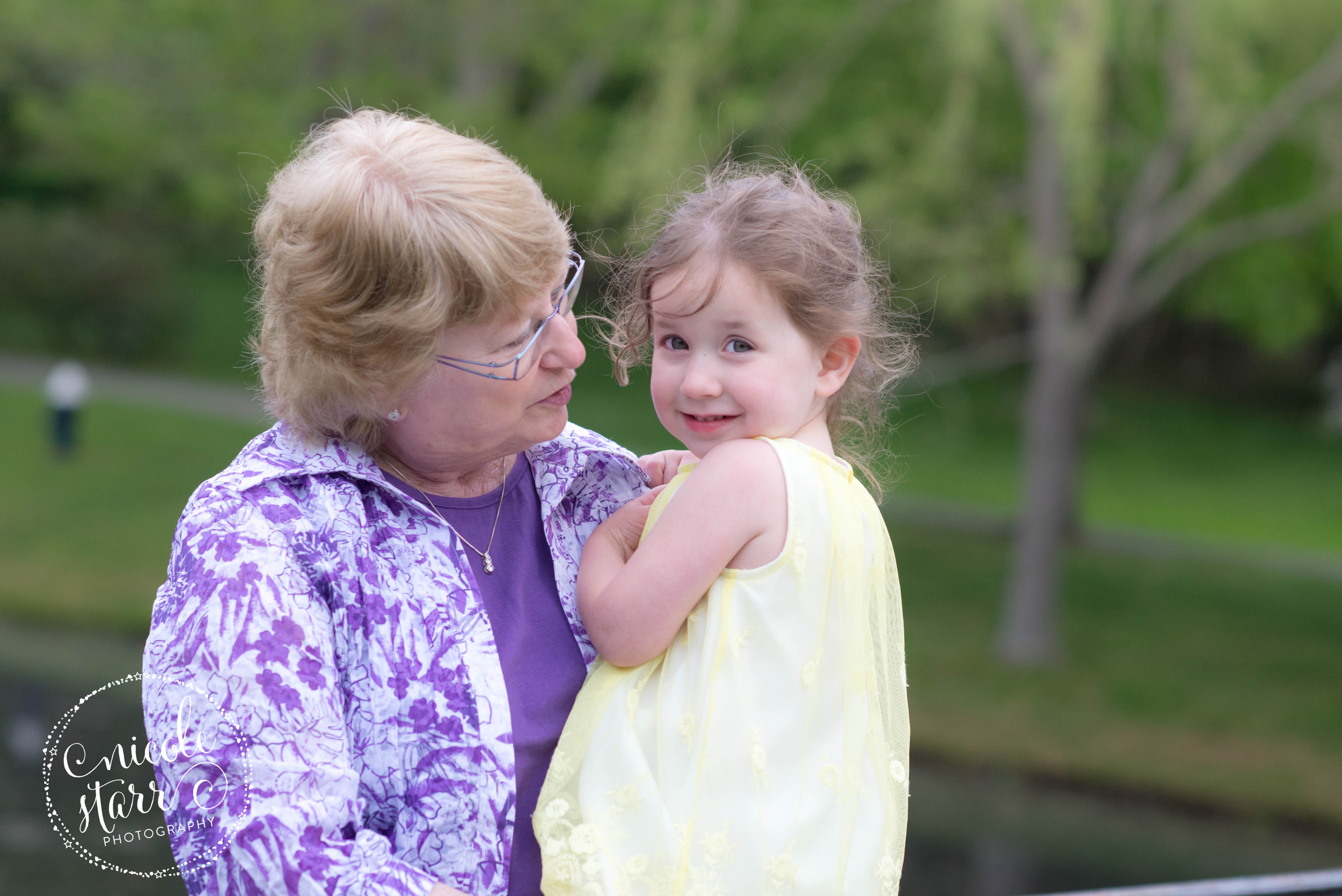 grandmother with granddaughter at a pond in brookline