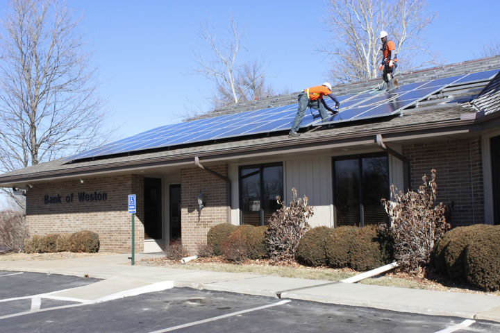 Workers installed 80 solar energy panels on the roof at Bank of Weston in Weston last week. Bank officials said its Platte City and KCI locations will also be outfitted with the panels this spring. SARA LOVELACE/Citizen photo
