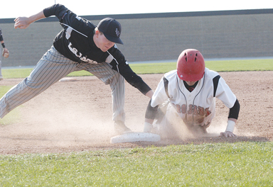 Park Hill’s Zach Serrano, right, dove safely back to the first base bag Monday afternoon in the Trojans’ loss to Lee’s Summit West.  LEE STUBBS/Citizen photo