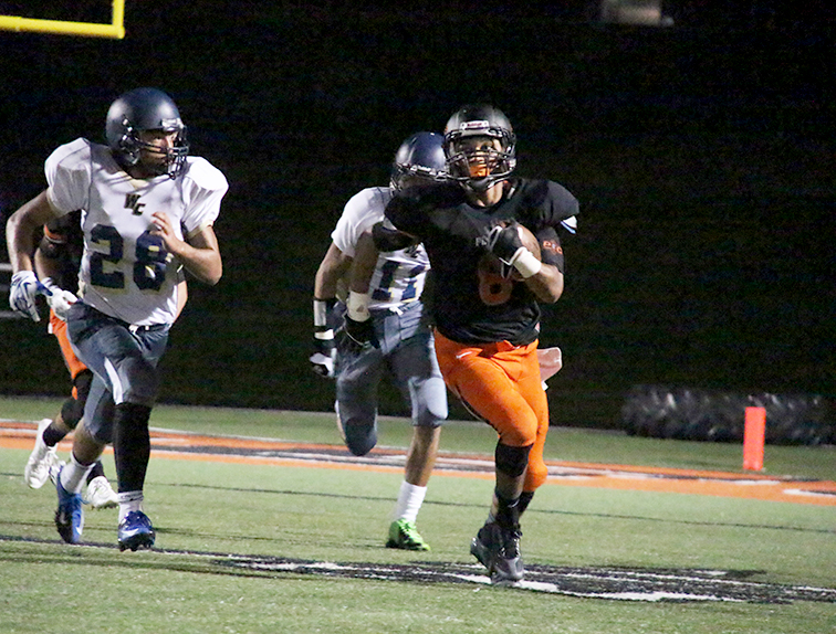 ROSS MARTIN/Citizen Photo Platte County wide receiver Aliek Reed, right, runs away from William Chrisman defenders Kyron Moss (28) and Chris Anderson (11) after hauling in a pass Friday Aug. 20 at Pirate Stadium. Platte County won 41-0 and looks to go 2-0 for the first time in seven seasons this week.