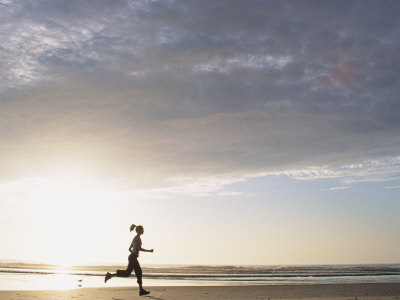 642494-FB~Woman-Running-On-Beach-At-Sunrise-Posters