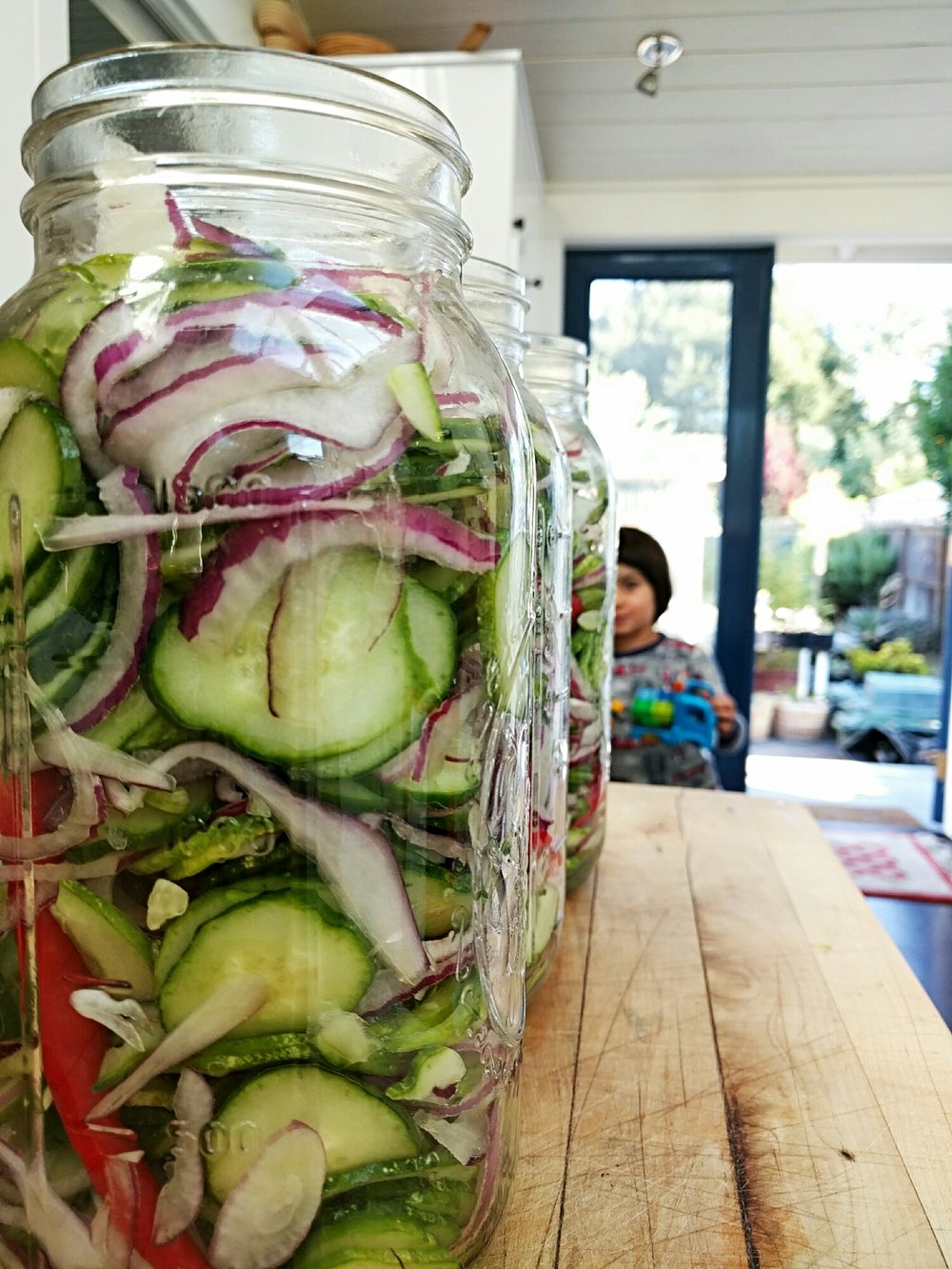 Sliced cucumber mixture just before pouring brine into jars