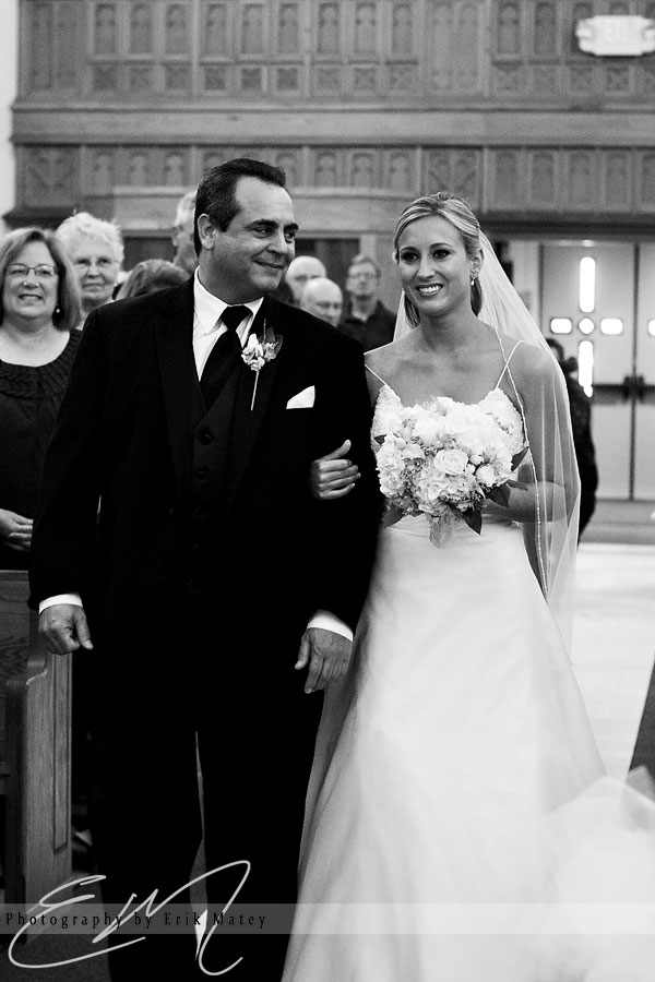 father and bride walking down aisle