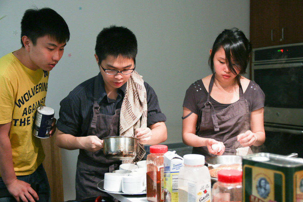  Members of Cookology, an on-campus student cooking group, prepare dishes for a recent Midnight Dinner. 