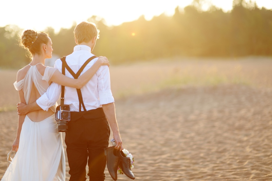 Bride and groom on a beach at sunset ©MNStudio 