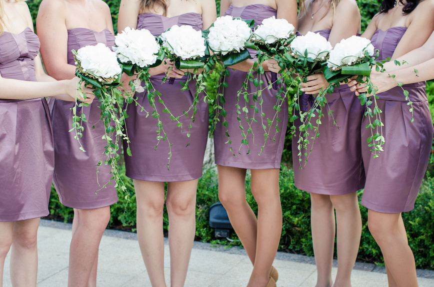 row of bridesmaids with bouquets at wedding ceremony