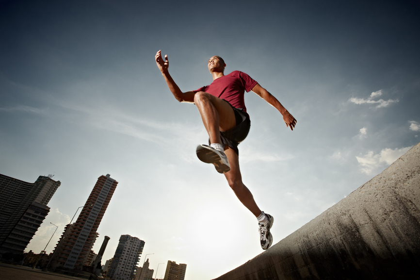 Man running and jumping from a wall