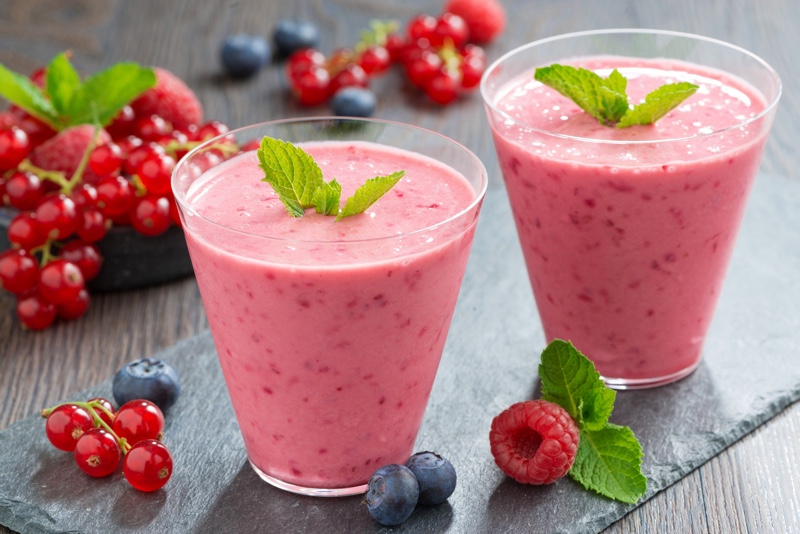 milkshake with fresh berries in a glass, horizontal