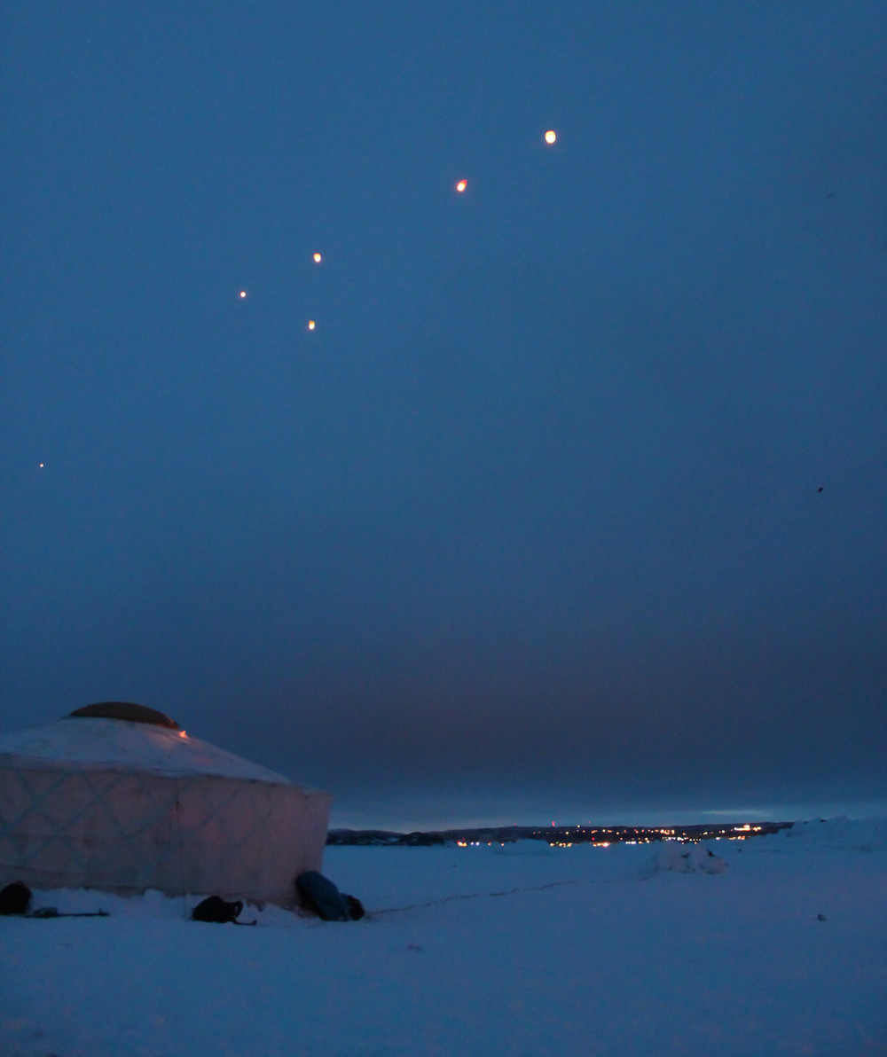 A magical moment, as the lanterns drift towards the town. Photo by Sara.