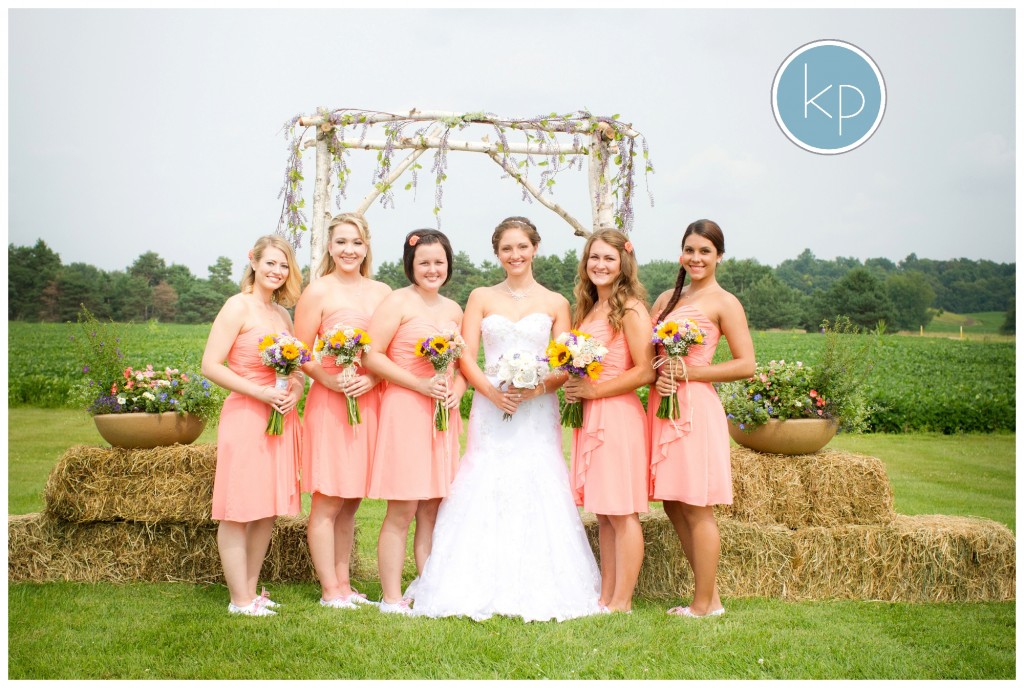 Bridesmaids posing with a bride at a lazy j ranch wedding by the alter