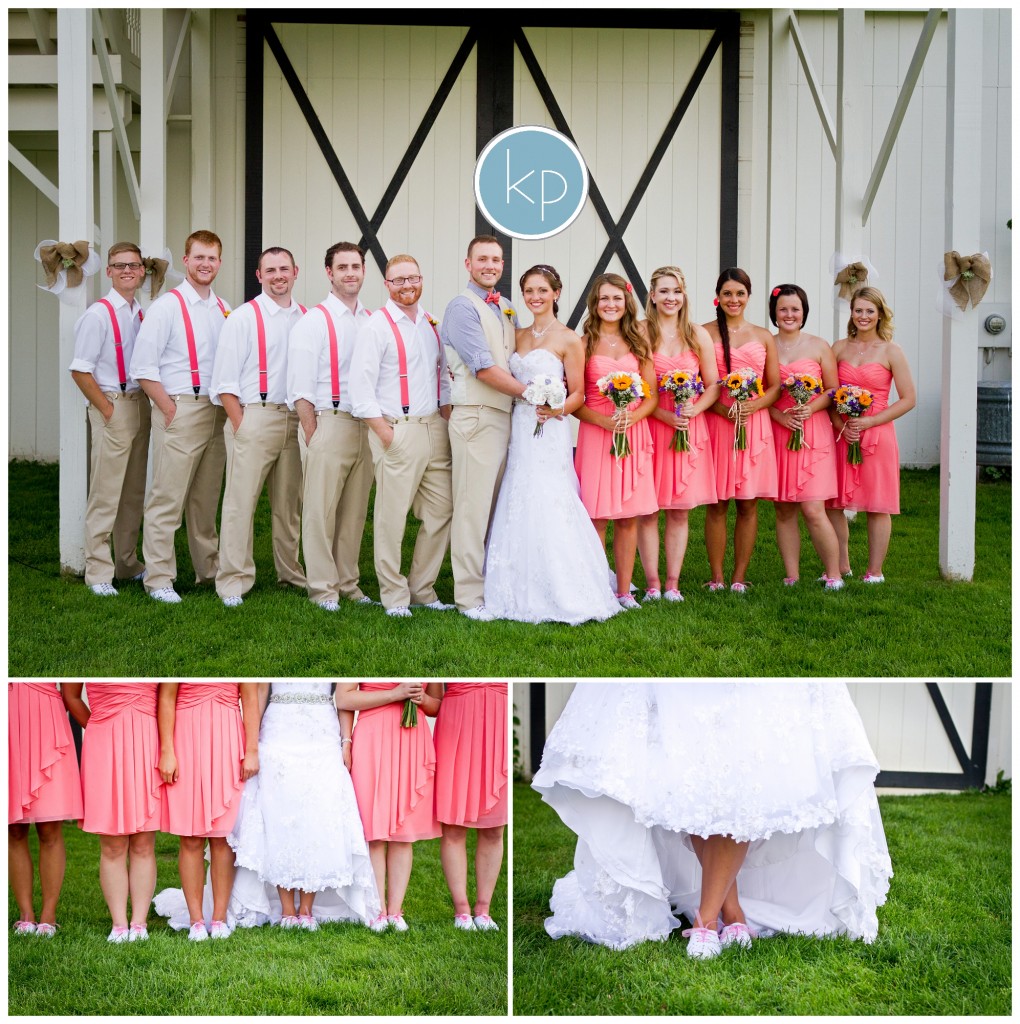 bride and groom posing with bridal party wearing pink dresses and pink spenders