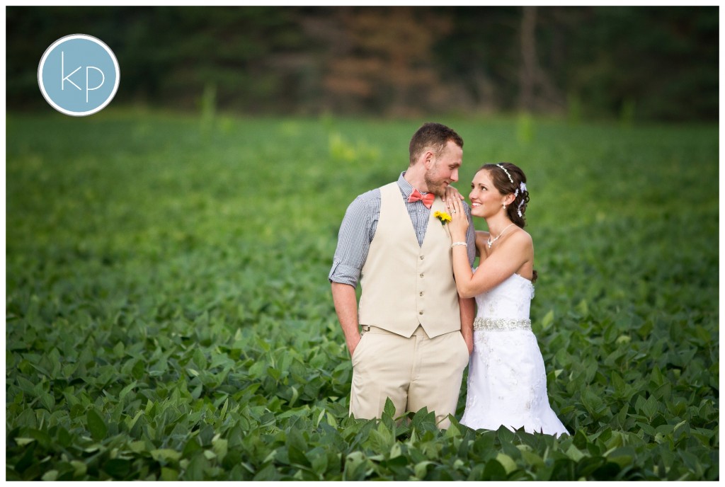 BRide smiling at groom in a soy bean field