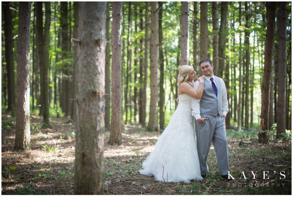 bride and groom in the trees in the wood