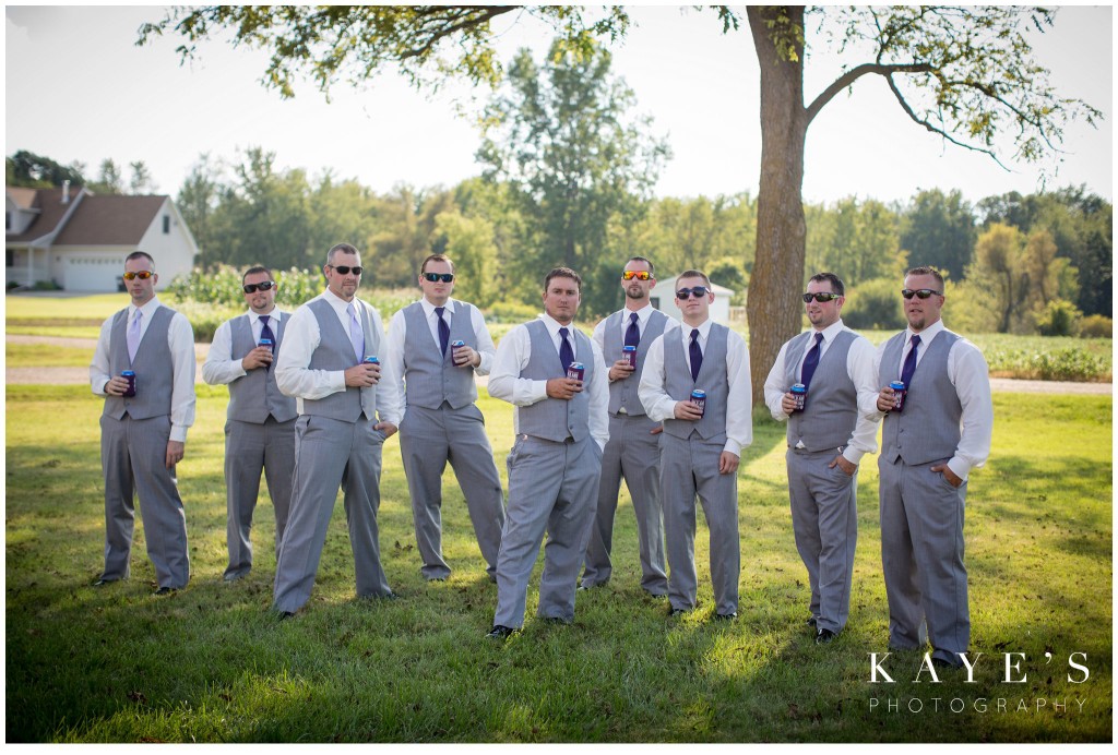 groom with groomsmen holding beers