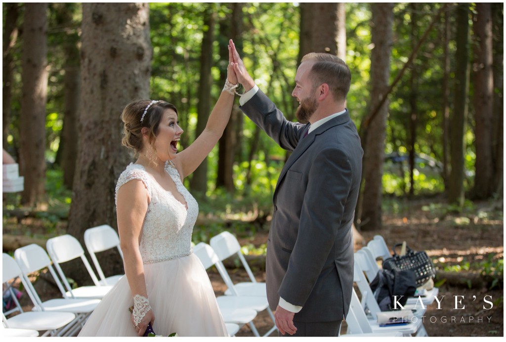 bride and groom high fiveing 