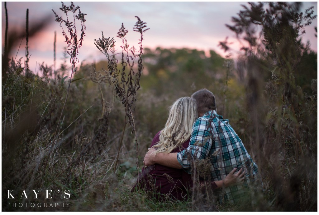 cuddle, couple, watching the sunset,  in the grass