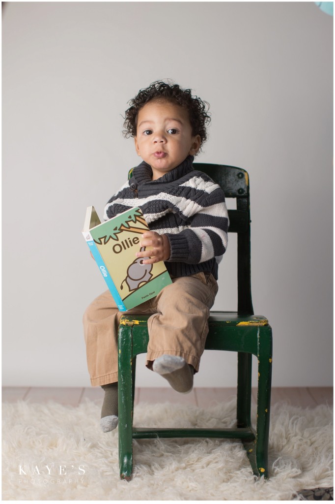 boy in chair, baby reading, closeup in chair