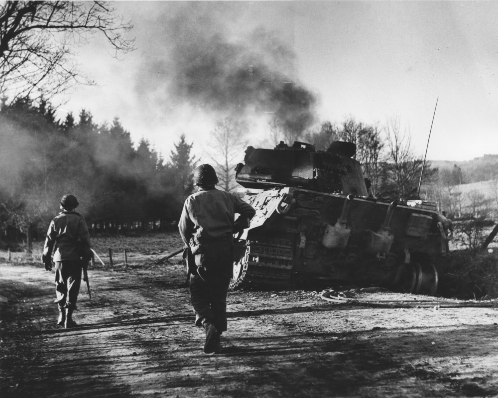 JoFl063_Outsied La Gleize, Two Infantrymen Move Move Past a Monstrous German King Tiger Tank, Dec 17, 1944