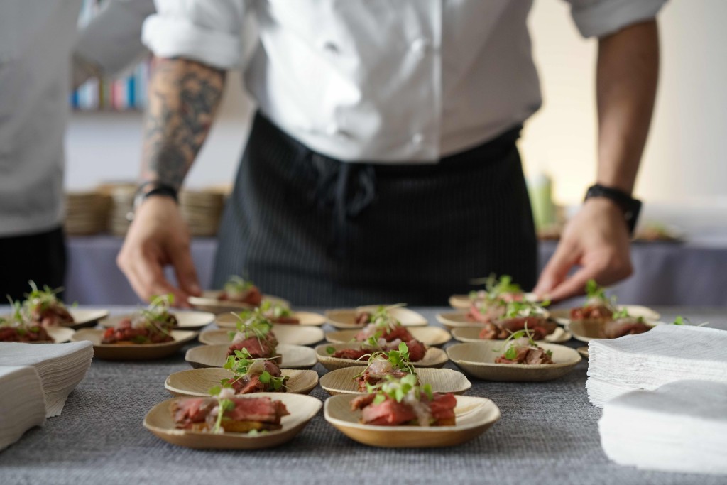 Chef Ed Scapone, from DBGB DC, plating his Seven Hills Farm beef with ramps on crostini. 
