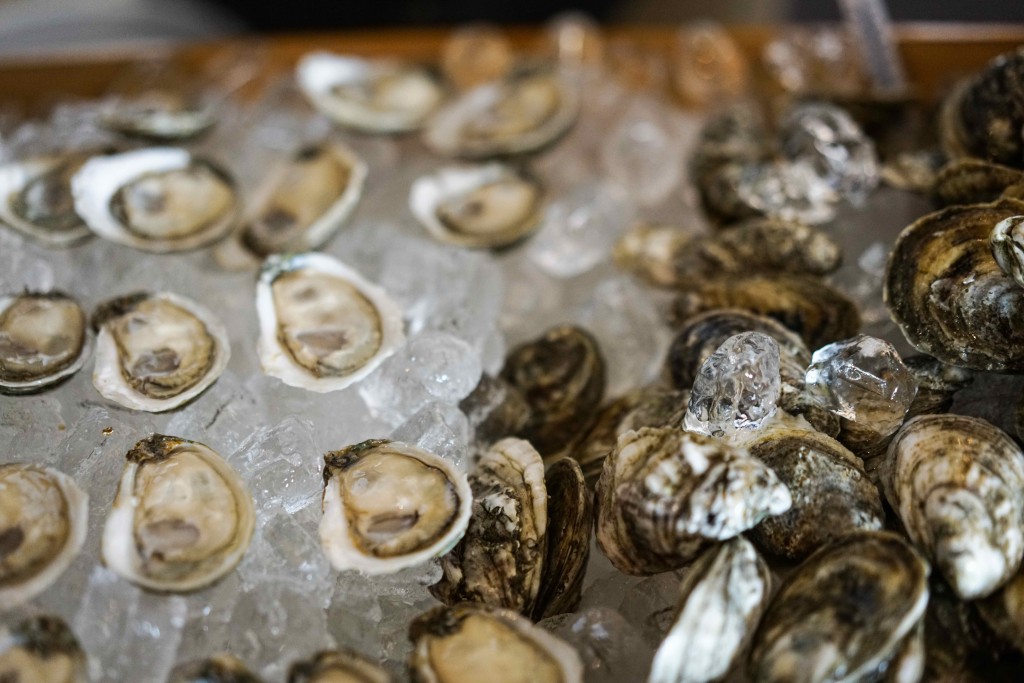 Guests huddled around Valliant Oysters proving you just can't have one. (Photo by Albert Ting)