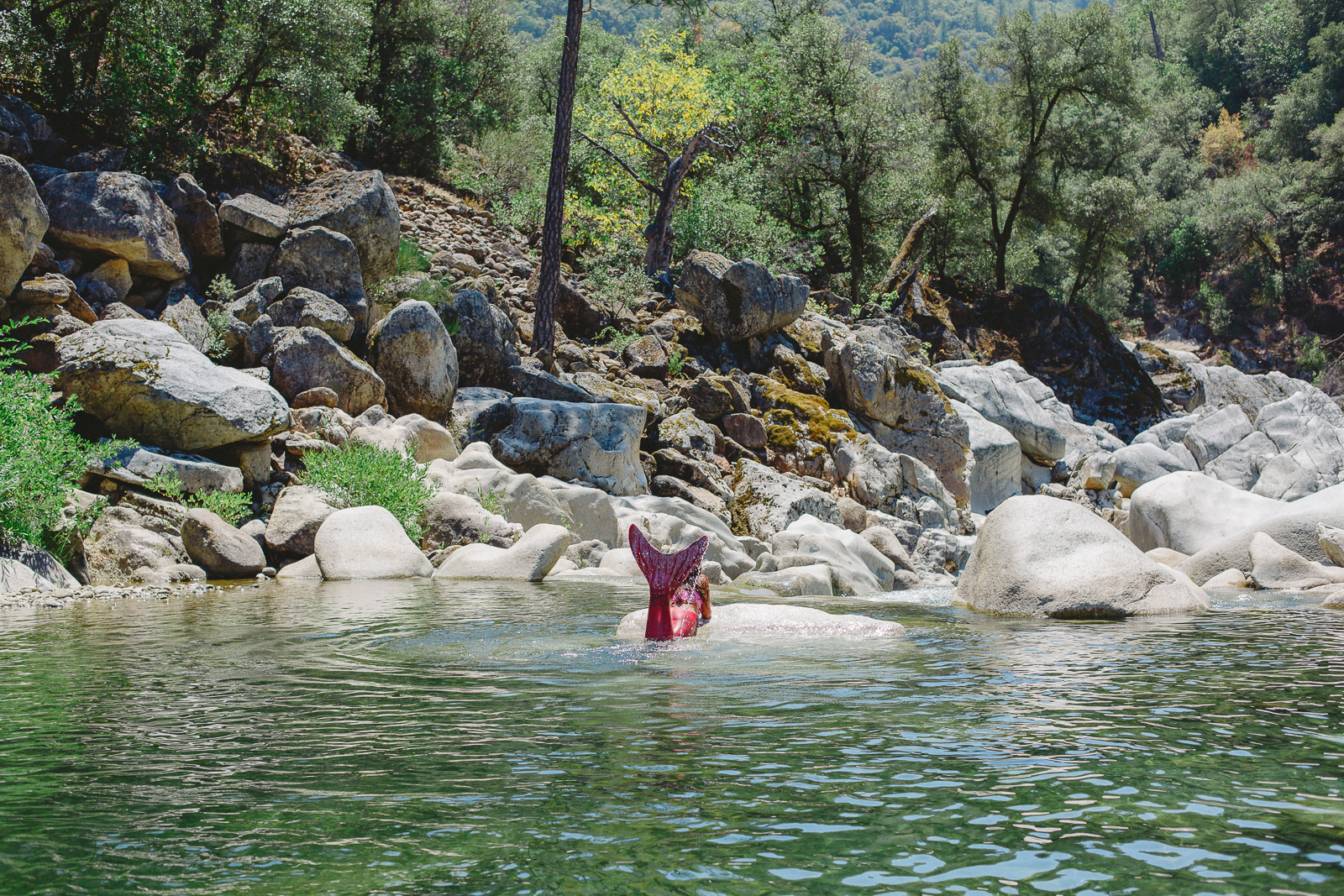 Mermaid sunning on the boulders at a mountain river