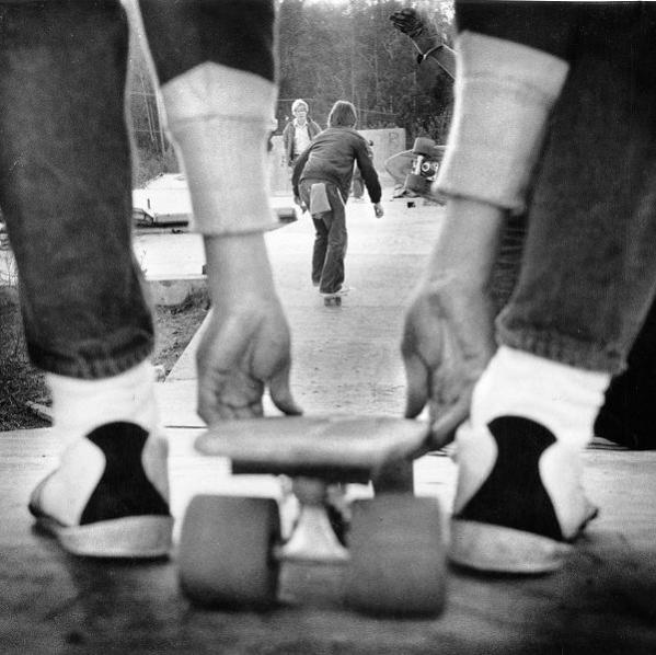Kids skateboard down a makeshift ramp. Photo taken Dec. 1, 1976. Location not specified.