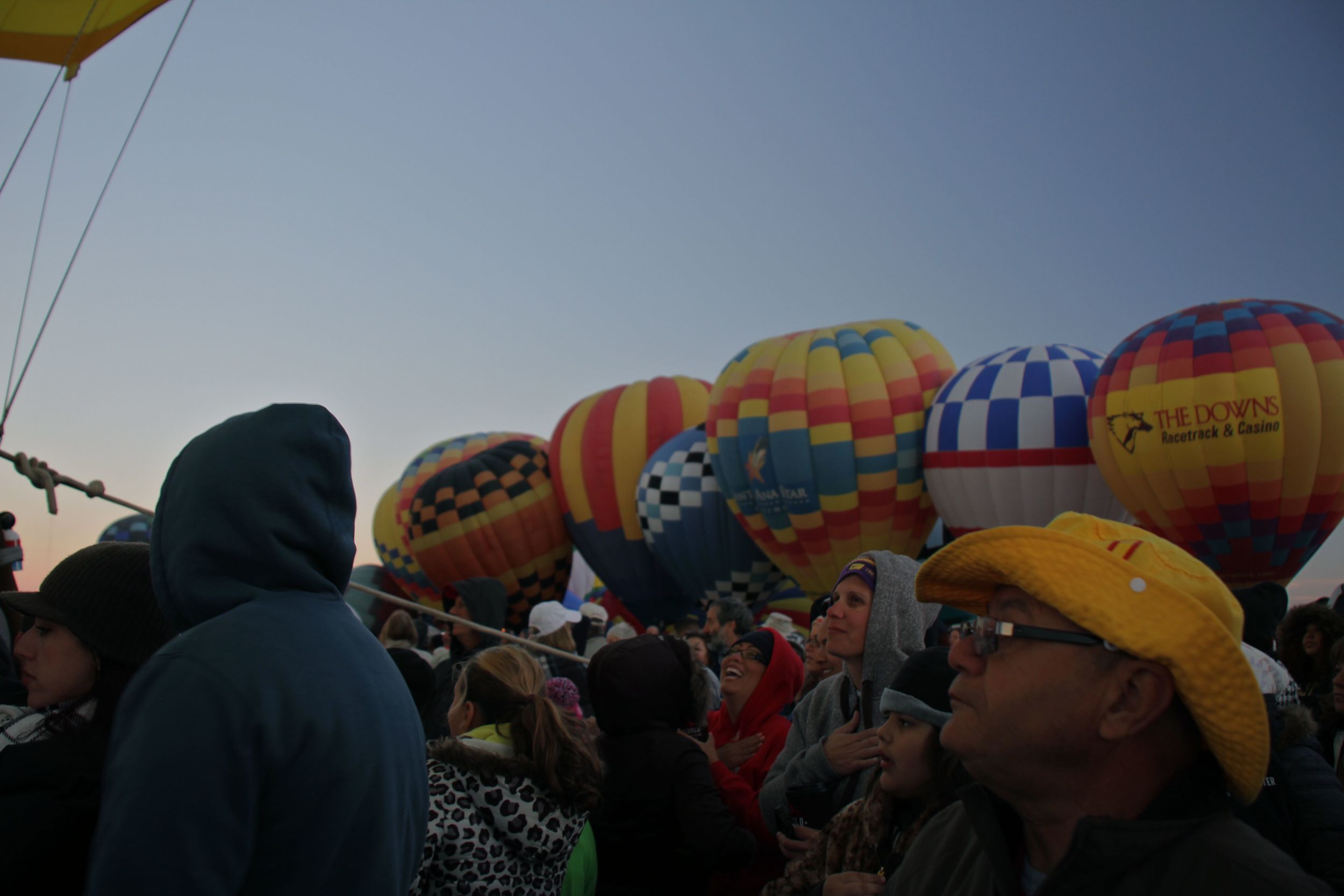 A wall of balloons rises around the crowd