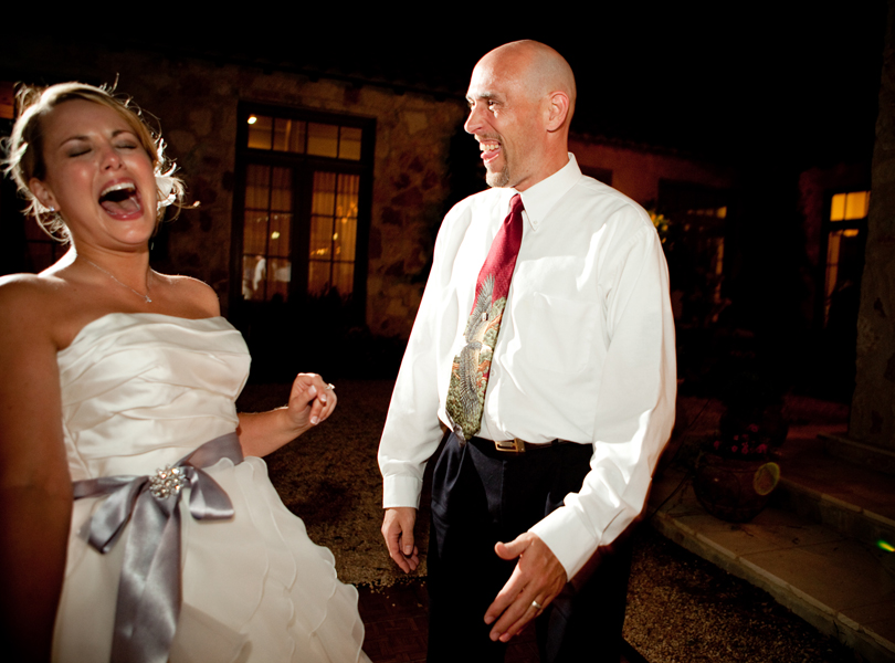 bride laughing with brother on the dance floor, wedding pictures