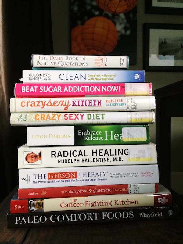photograph of a stack of books on healing from cancer