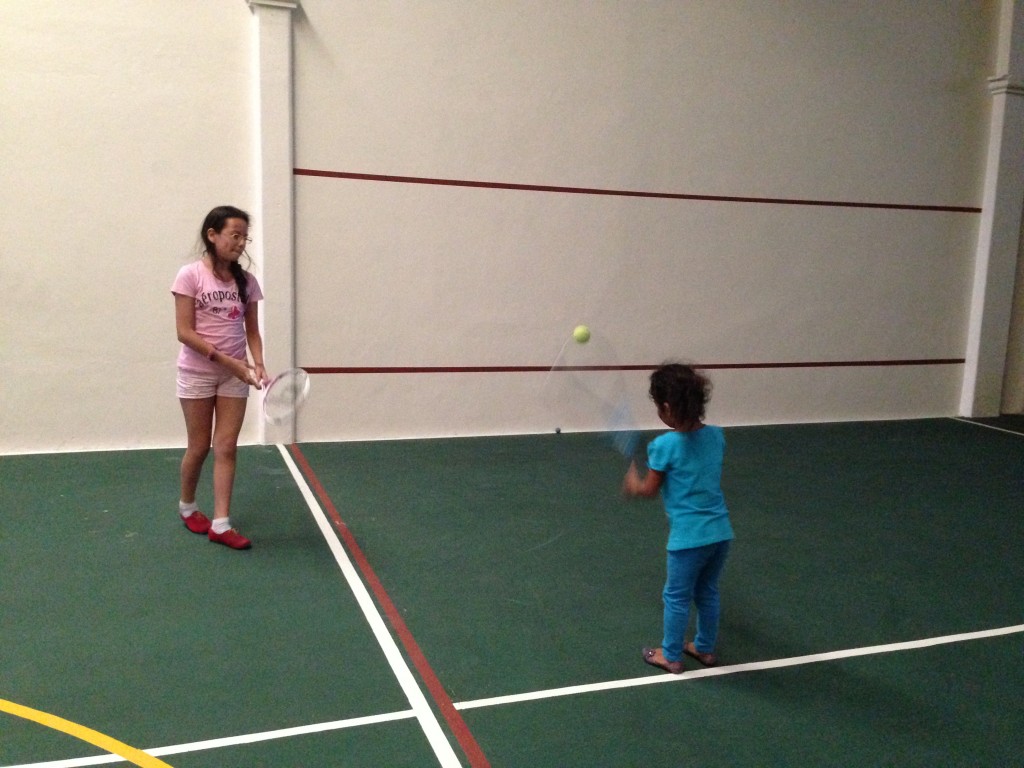 The girls learn the finer points of tennis.
