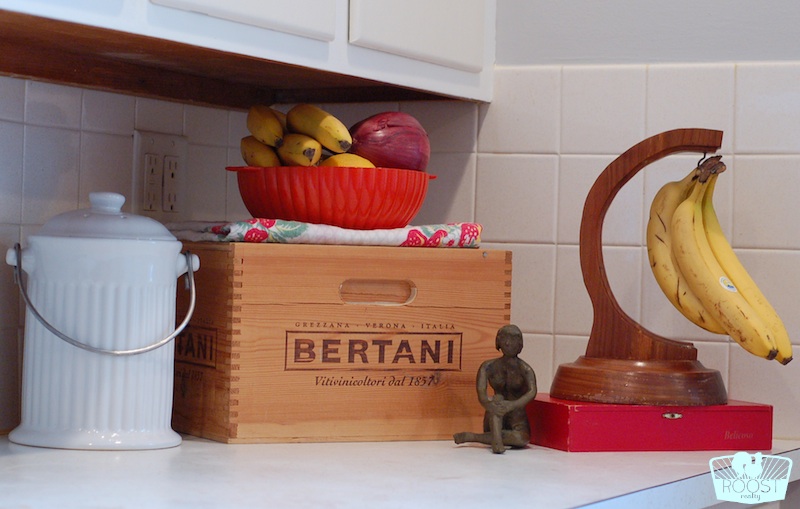 A variety of wood boxes and containers displayed on a kitchen counter.