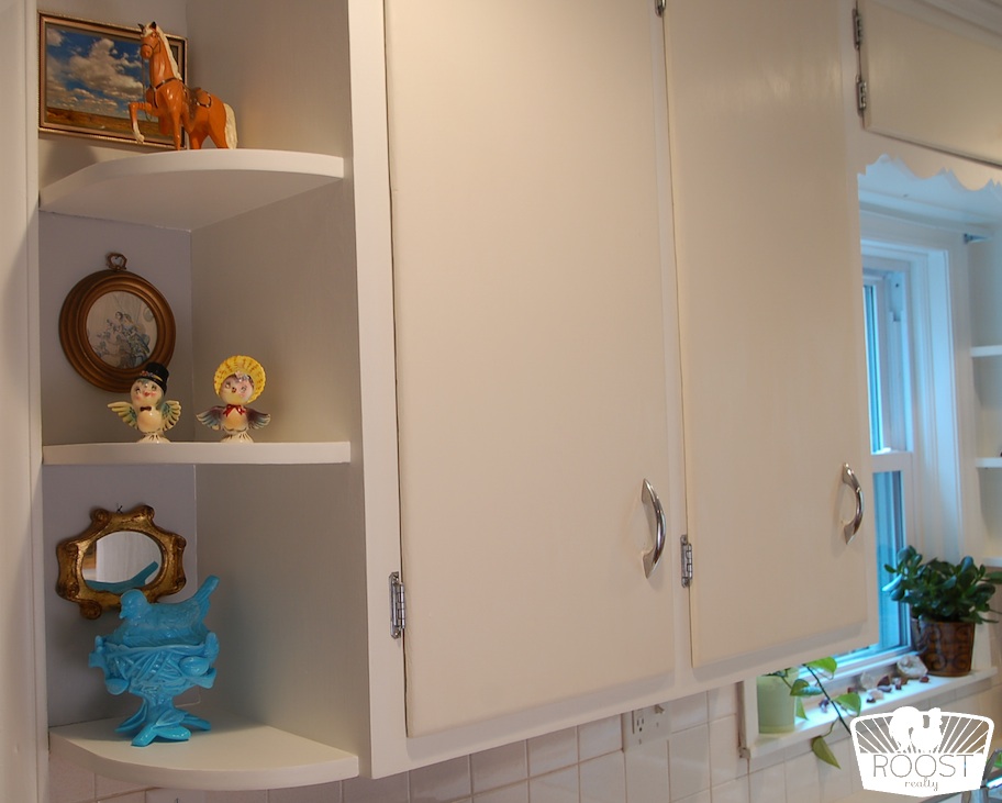 Built-in kitchen shelves holding vintage knick knacks.