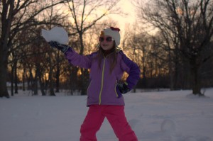 girl holding snow roller