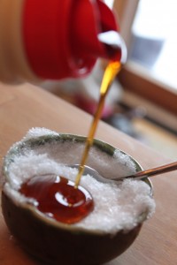 pouring maple syrup on snow