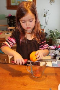 child shaving orange peel