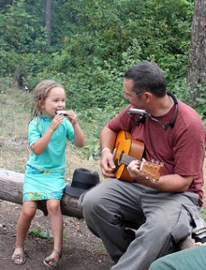 child playing harmonica with grandfather