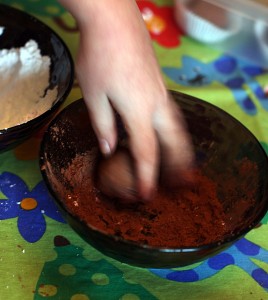 rolling truffles in cocoa powder