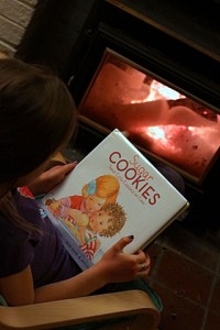 reading sugar cookies book by the fire