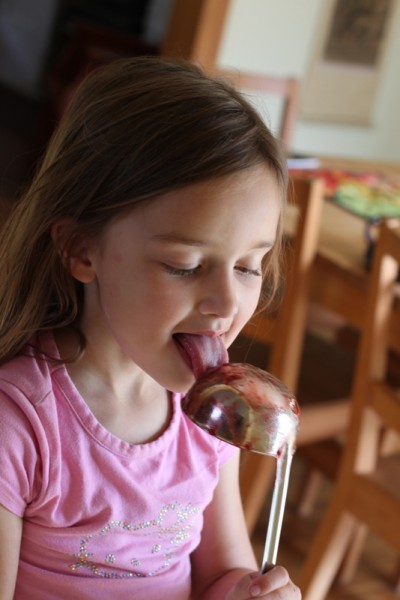 child licking jam ladle