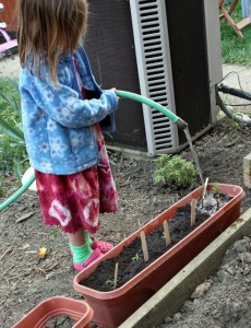 child watering garden