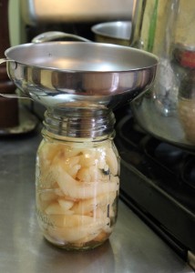 ladling pears into sterilized jars