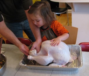 child helping to cook a turkey