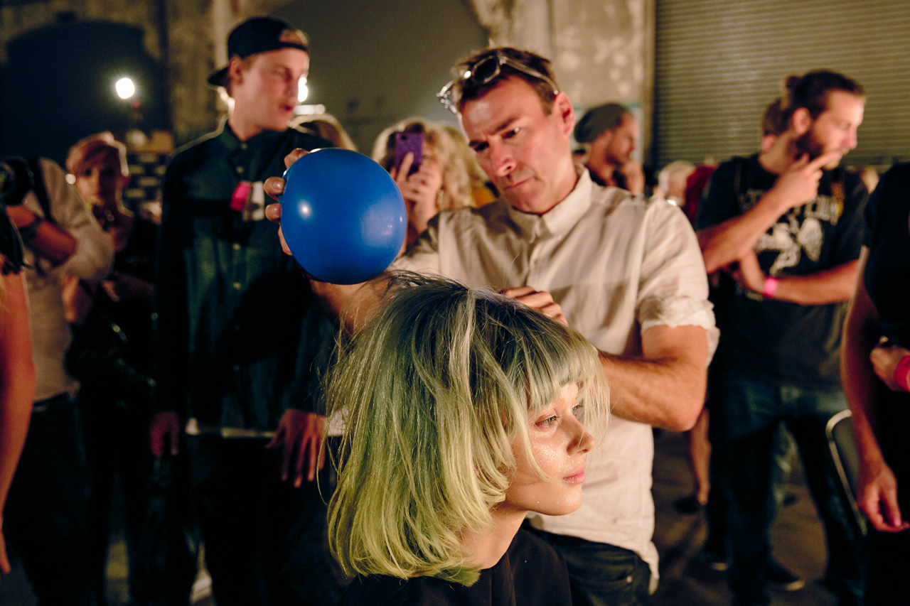 Alan White for ghd uses the static from a balloon to get the hair messed just right