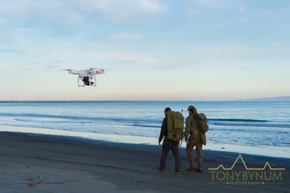 drone filming two men on beach