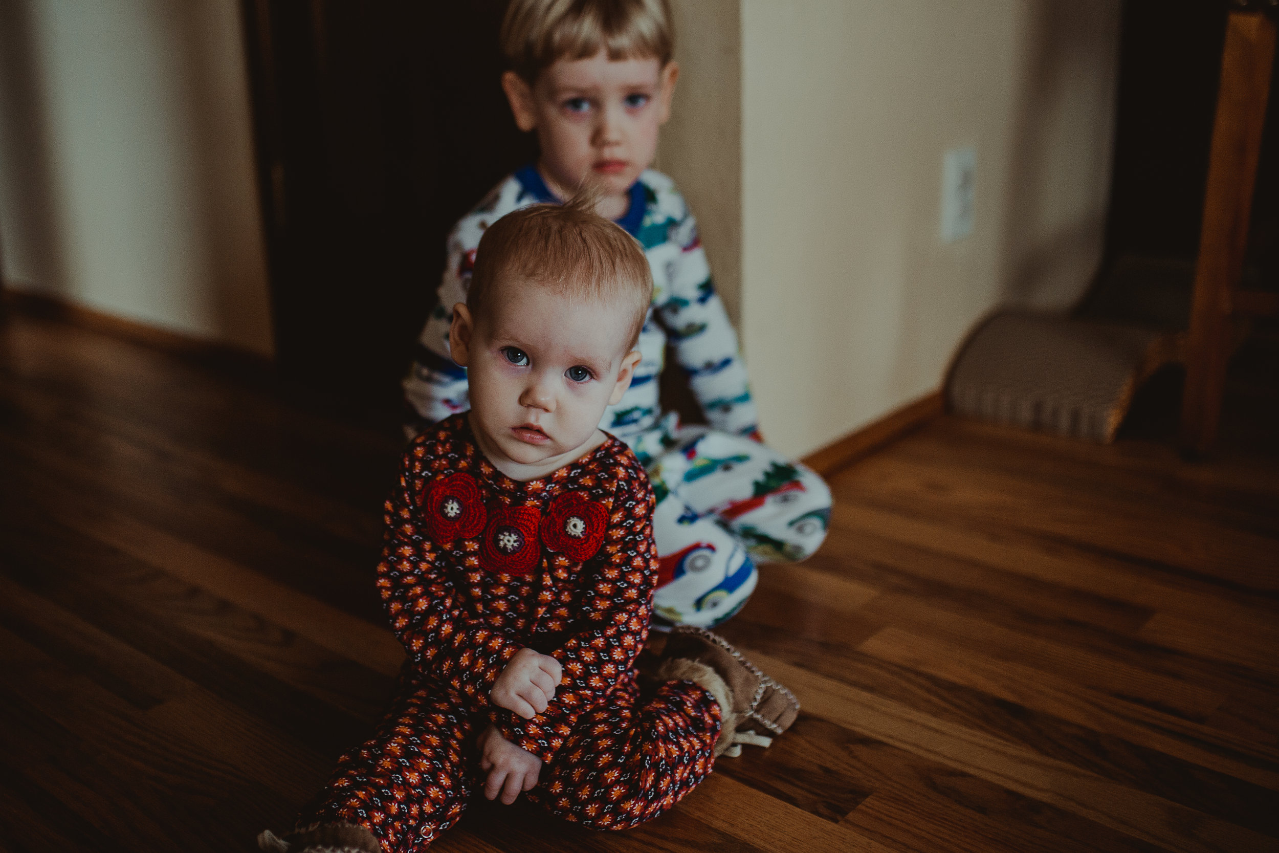  Baby girl in pajamas with brother in Southern Oregon home. 