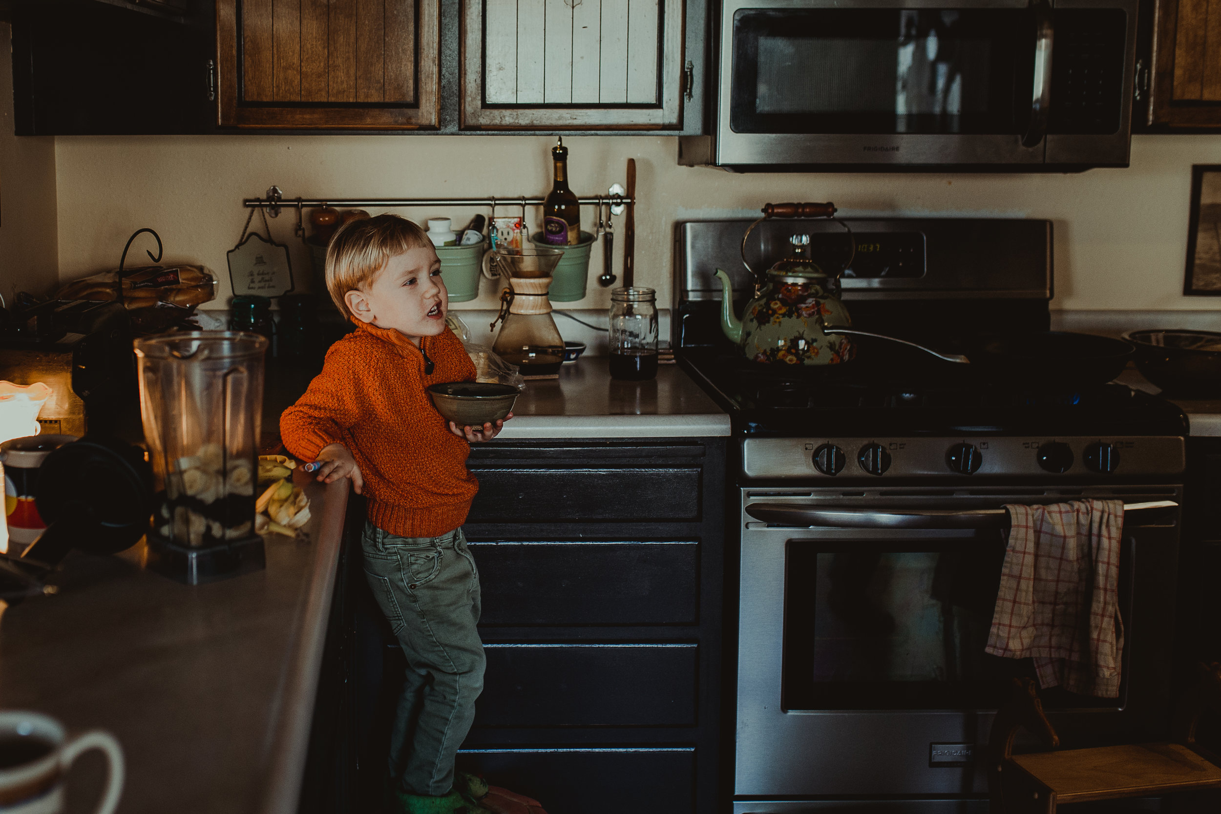  Boy holding blueberries in bowl 