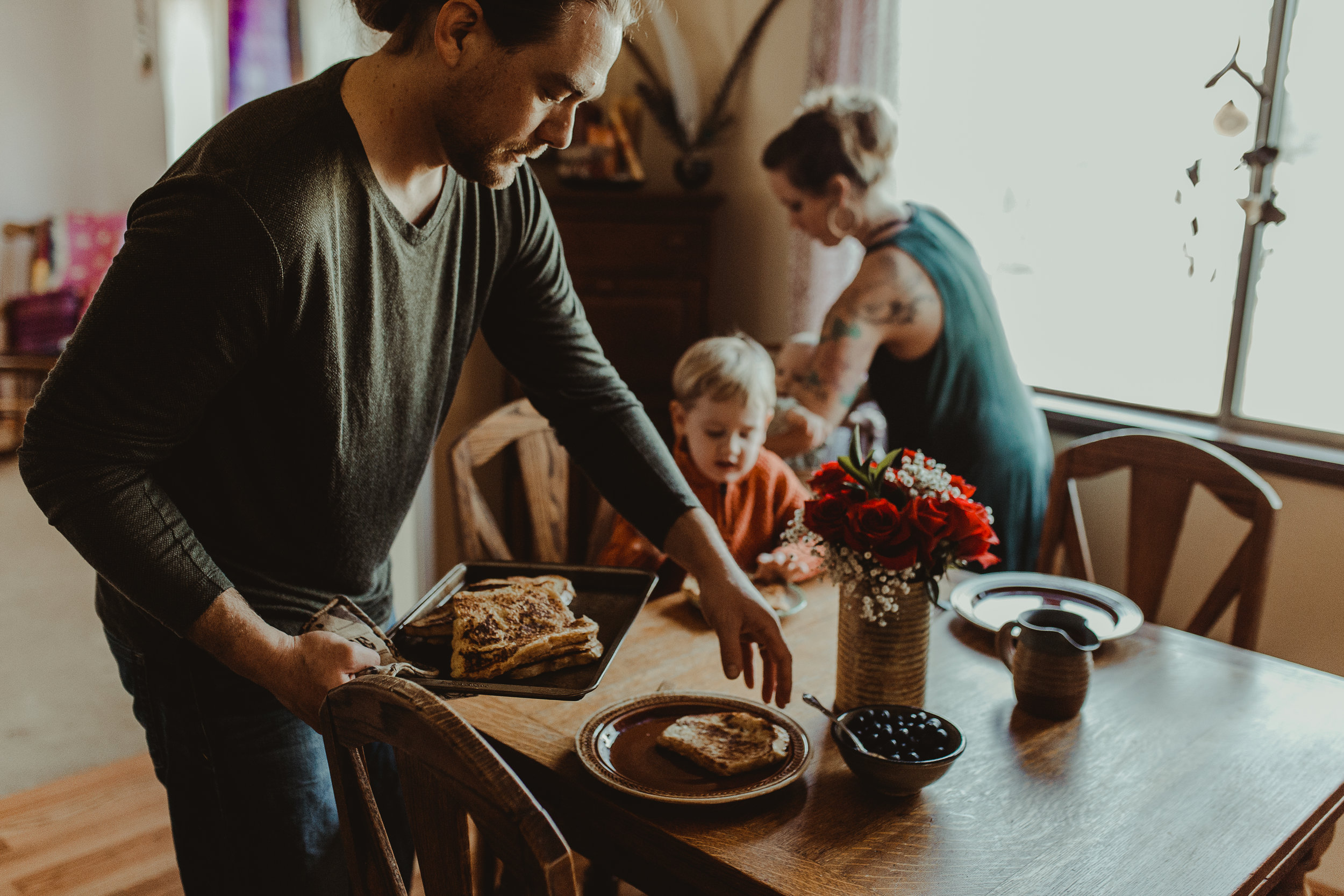  Dad serving breakfast to family at table 