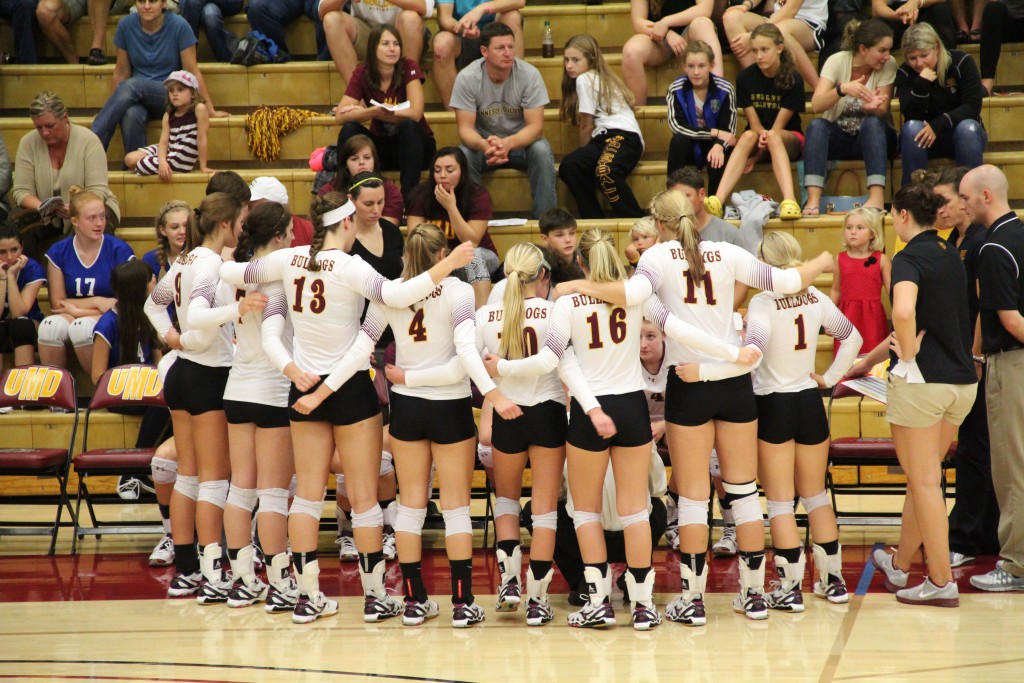 The Bulldog volleyball team talks strategy during a timeout in their three-set sweet over Minnesota-Crookston on Thursday. MADDIE GINSBERG/STATESMAN