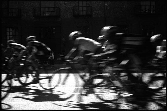 black and white photograph: cyclists, front street, san francisco