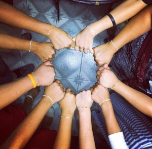 The girls at the Home of New Beginnings proudly wear their bracelets given to them on the 2015 trip.